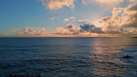 drone amazing evening seascape on rocky shore. sunset light reflecting in ocean