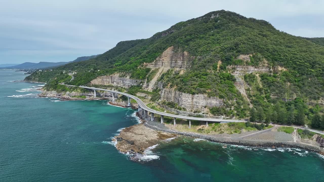 Approaching the Sea Cliff Bridge over the Pacific Ocean and rocky shoreline in NSW Australia