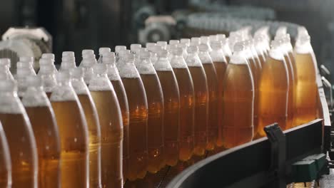 conveyor belt with bottles for juice or water at a modern beverage plant. modern production of sweet soda water