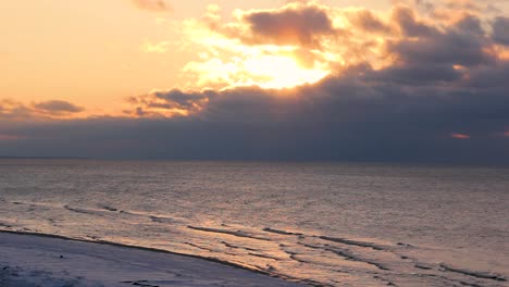 colorful winter sunset on the shore of the gulf of riga in latvia saulkrasti white dune