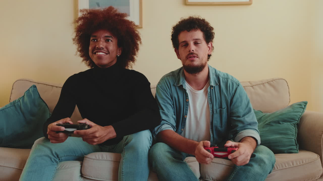 Two men playing video games on the couch