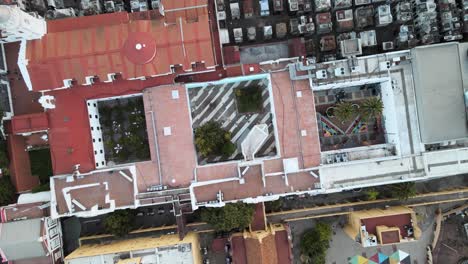 Aerial-top-down-shot-rising-above-The-Recoleta-cultural-centre-and-cemetery-beside