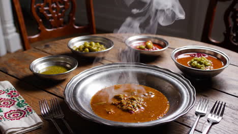 hot steaming soup with side dishes