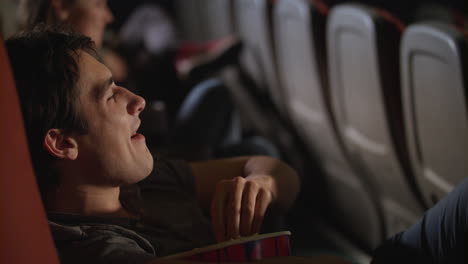 young man watching comedy film in the cinema