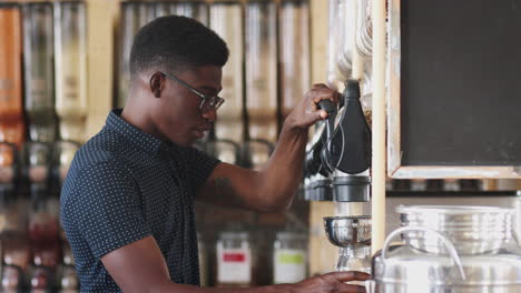 Man-Filling-Container-From-Dispenser-For-Grains-And-Cereals-In-Plastic-Free-Grocery-Store