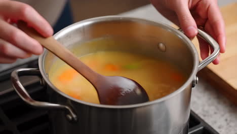 stirring vegetables in a pot of soup