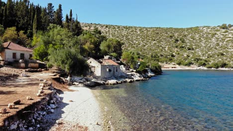 view along the coast with old houses at agia sofia beach in kefalonia, greece - drone shot