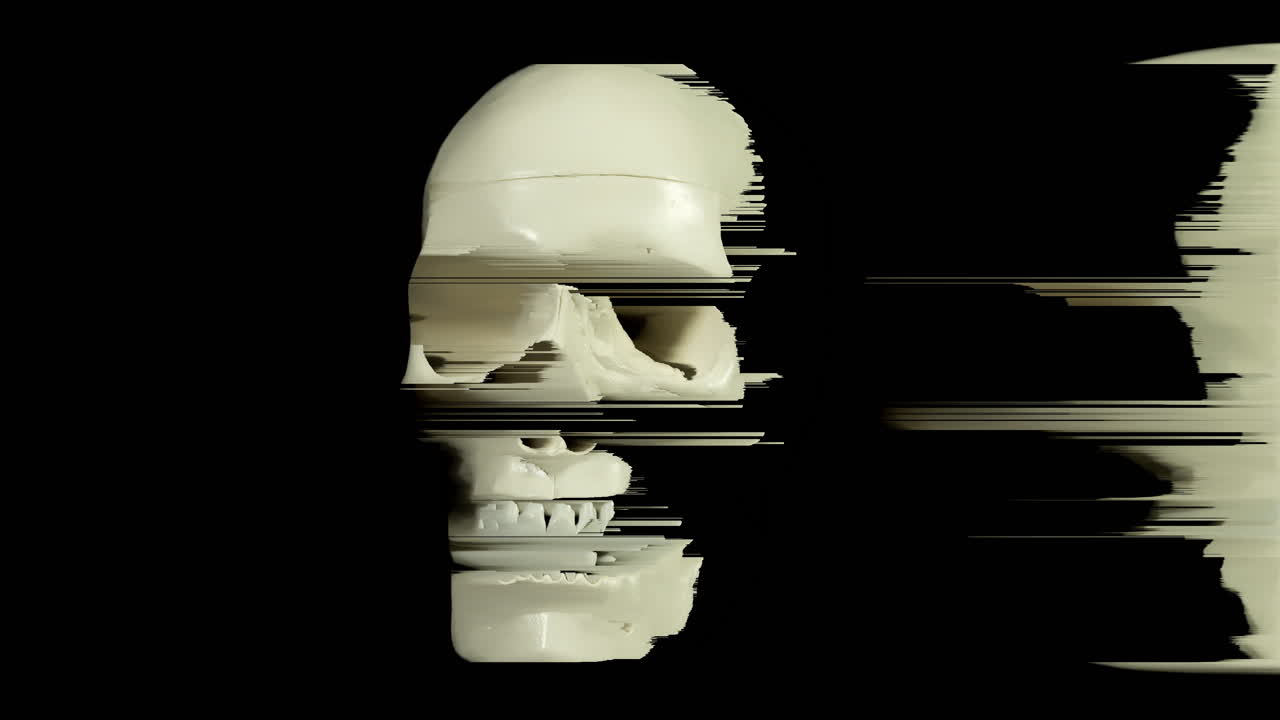 Human skull turning on black