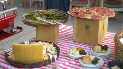 ham, bread and other italian food at a table on a wedding