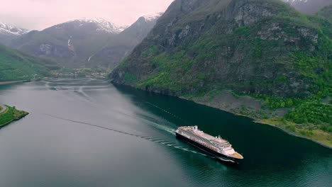 aerial view of cruiser ship on natural fjord of norway between mountains during cloudy day