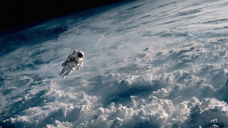 An Astronaut Gliding Through the Expansive Sea of Clouds Above Earth, Capturing the Infinite Beauty of Space and Our Planet's Atmosphere
