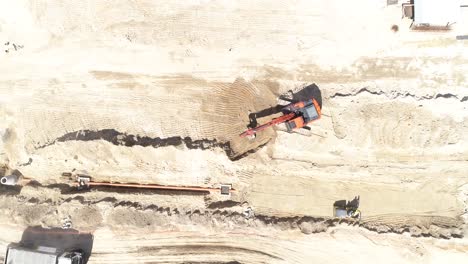 Top-View-of-Excavator-and-Trucks-in-construction-Site