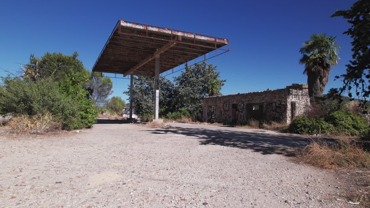 Abandoned gas station, pedestal panoramic shot moving up and left