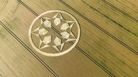 geometric crop circle formation in wheat field in marten, wiltshire, england, uk - drone shot