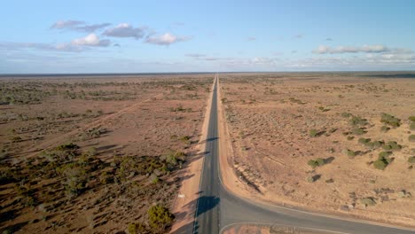 Vista-Aérea-Por-Encima-De-90-Millas-De-Carretera-Recta,-Australia-En-Un-Soleado-Desierto-Interior,-Inclinación,-Disparo-De-Drones