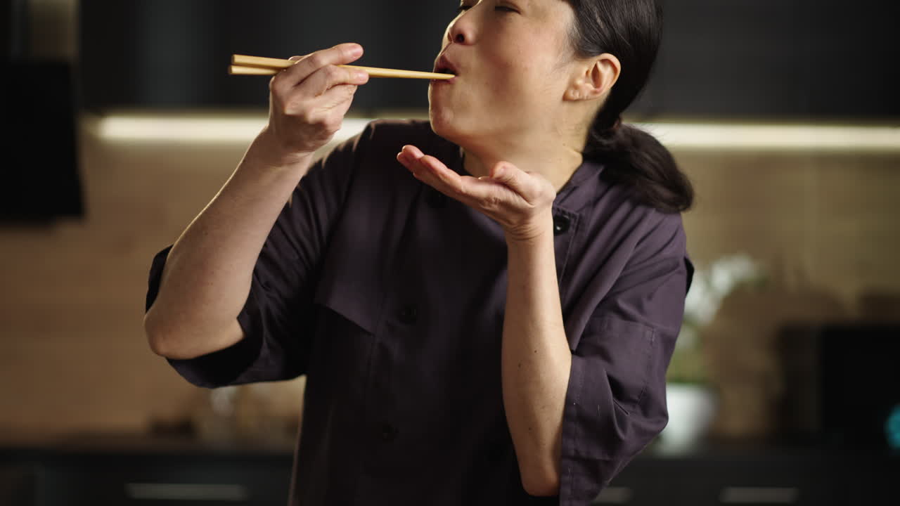 Woman tasting sushi in the kitchen