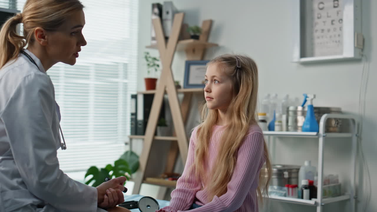 Girl talking pediatrician appointment in clinic closeup. Smiling woman consult