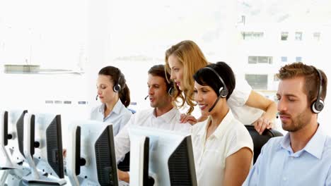 Supervisor-checking-on-call-centre-workers