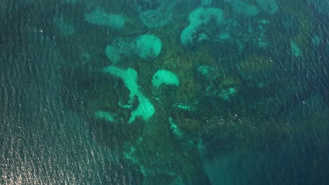 aerial shot over coral reef and blue ocean in nsw, australia