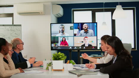 headshot screen application view of remote multiracial employees talking on video call