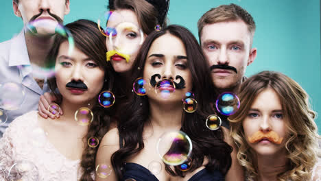 multi racial group of people wearing false mustache for movember slow motion party photo booth