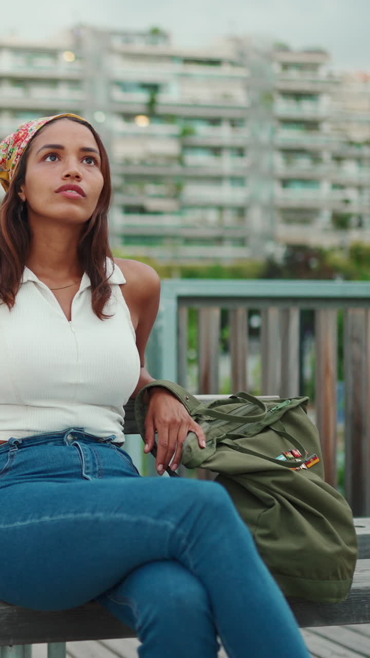 A woman sitting outdoors on a bench