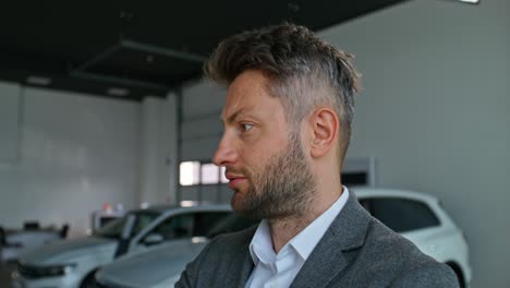 man in a car showroom