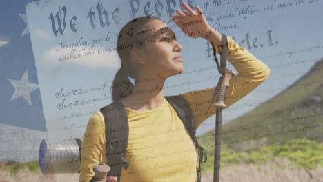 animation of american flag over biracial woman looking away in mountains