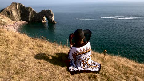 Woman-sitting-on-a-cliff-4K-slow-motion