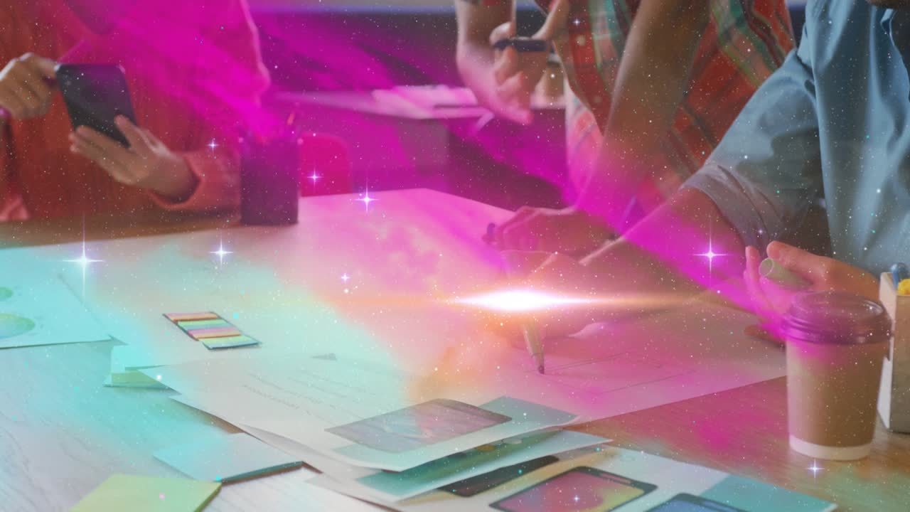 Design team leaning over table sketching marker sparking teal aurora sweeping over table for review