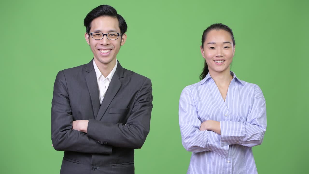 Young Asian business couple with arms crossed together