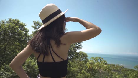 young women with hat exploring a beautiful  caribbean island with an ocean view
