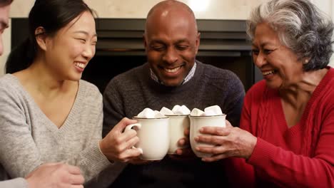 warm moments of joy: a group of friends enjoying hot chocolate with marshmallows by the fireplace, sharing laughter and good company in a cozy atmosphere