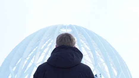 man looking at a dome structure