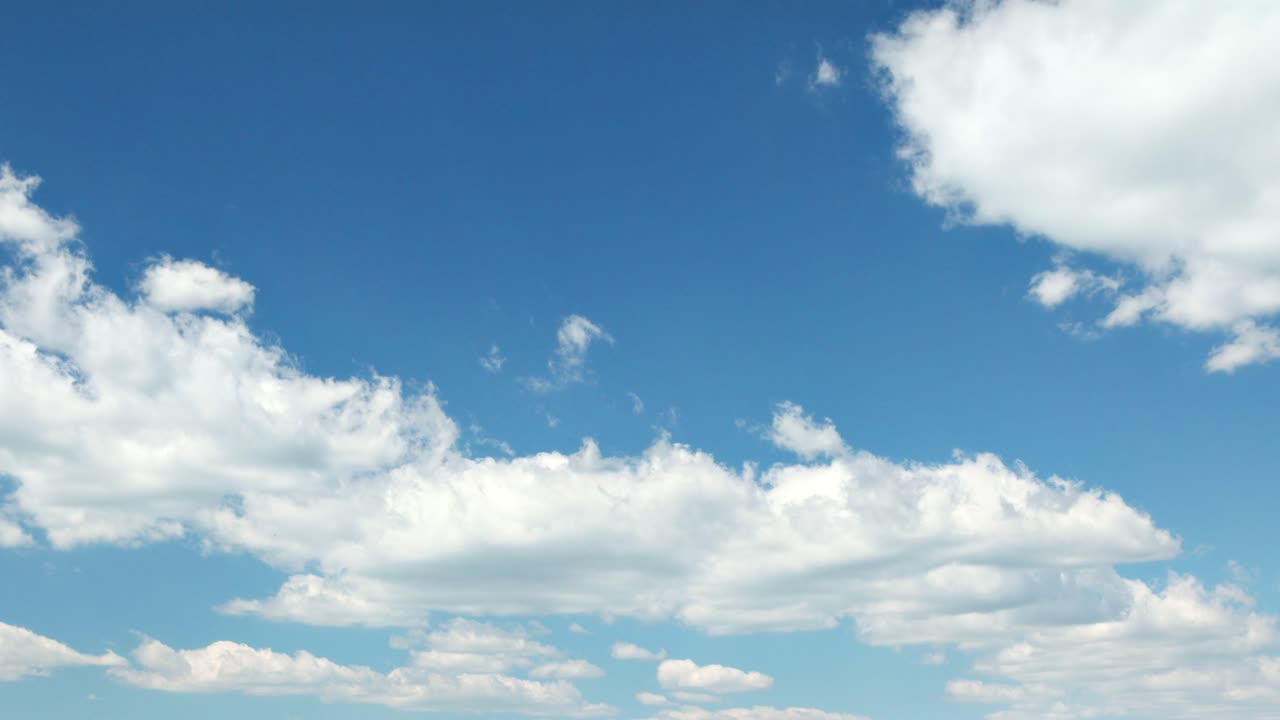 Blue sky with billowing white clouds time-lapse