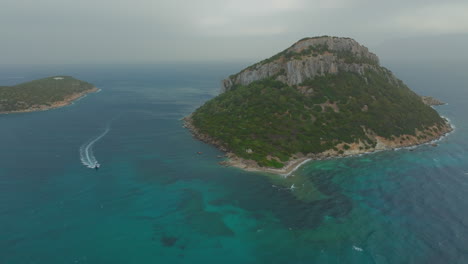 Aerials-that-Amaze:-Figarolo,-Beauty-of-its-Azure-Waters,-and-the-Graceful-Mountain