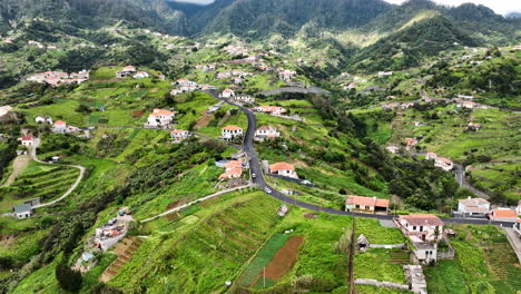 fertile farmland and scattered houses on dramatic landscape, madeira