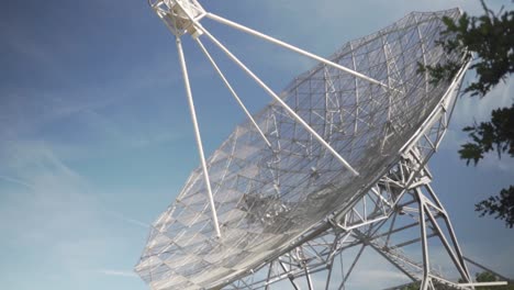 large radio telescope against a blue sky