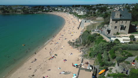 People-bathing-and-sunbathing-on-Minihic-beach,-Saint-Malo-in-Brittany,-France