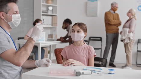 caucasian doctor injecting school girl