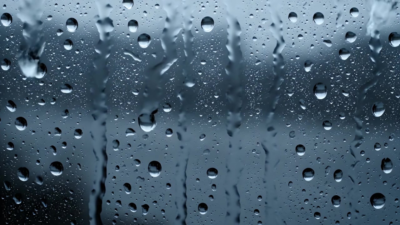 Raindrops Running Down a Window Pane on a Gloomy Day