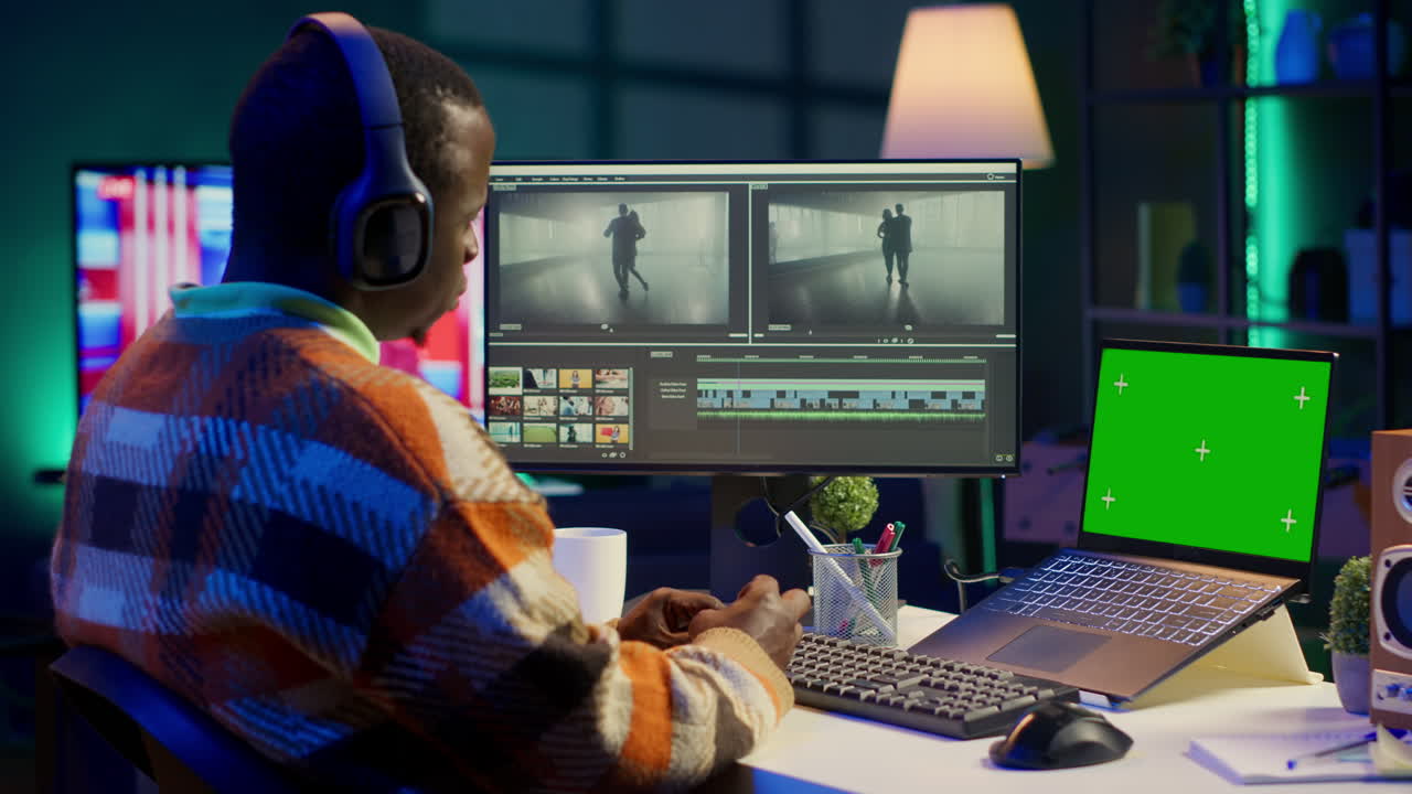 Video editor working on a project with green screen laptop