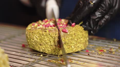 Pistachio-croissant-donut-being-cut-in-half