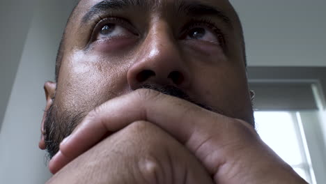 middle aged asian male reading on computer screen, close up on face