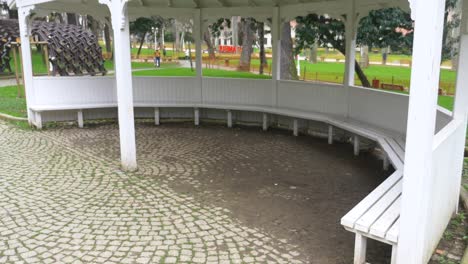 white wooden gazebo in a park