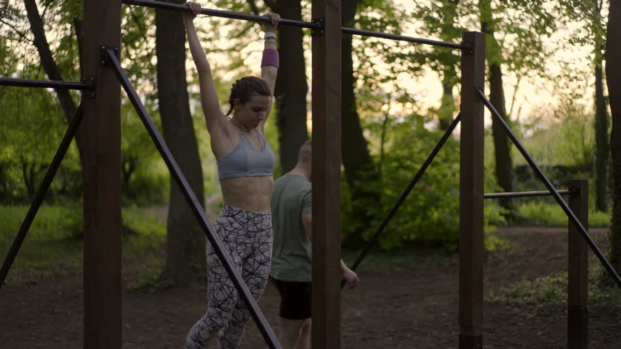 Woman doing pull-ups in park