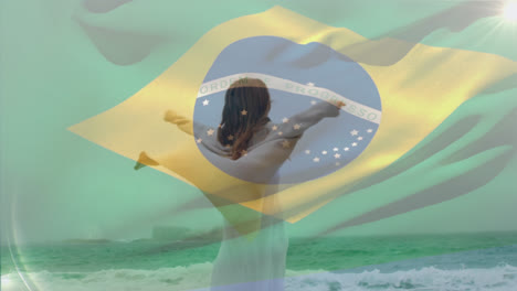 composite video of waving brazil flag over caucasian woman enjoying at the beach
