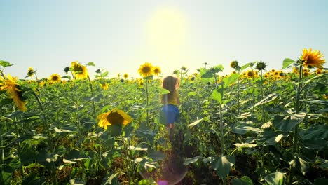 girl running through a sunflower field