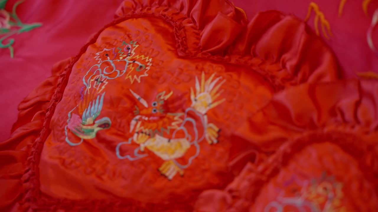 Red silk bedding with embroidered dragon and phoenix symbols