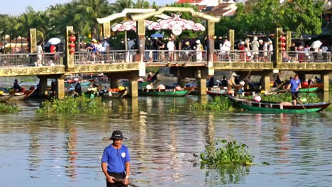 rowboats on the scenic thu bon river at the old quarter in the city of hoi an, vietnam.